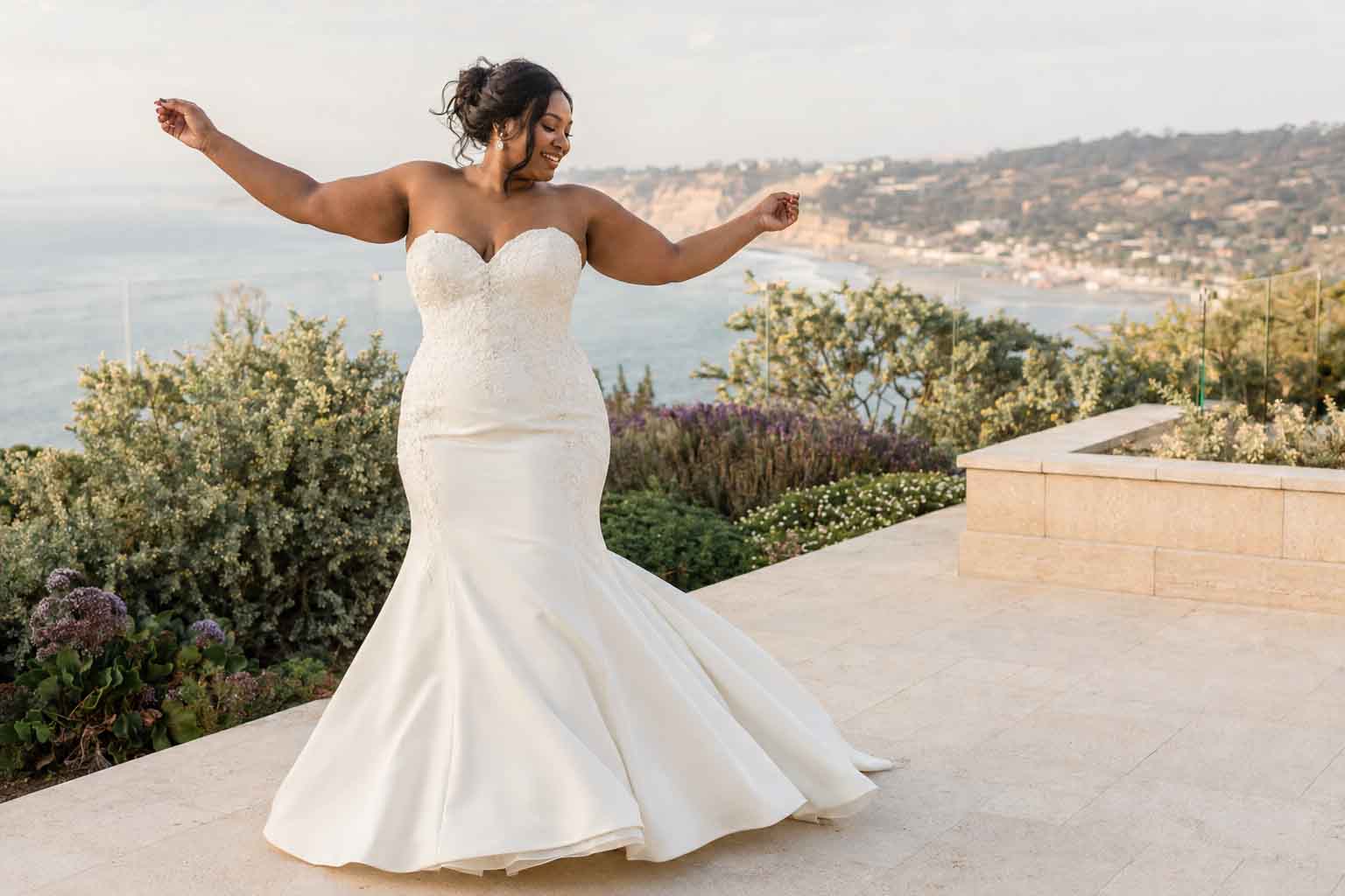Bride performing a movement test in a supportive strapless wedding gown