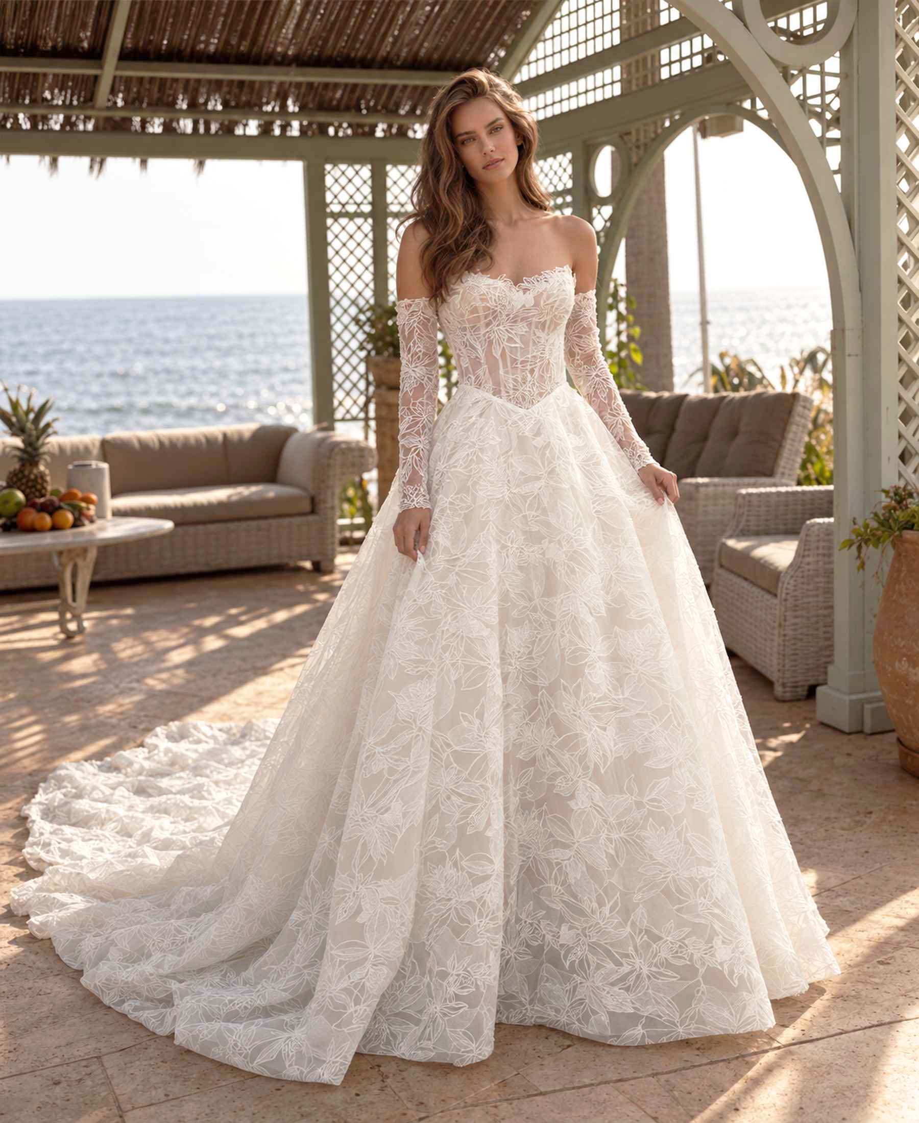 Mercedes off-the-shoulder floral lace ball gown wedding dress by Navid Noor Couture with long lace sleeves